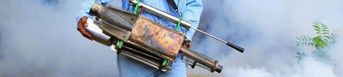 Fumigation technician using a fogger for deep pest treatment in Eugene, OR