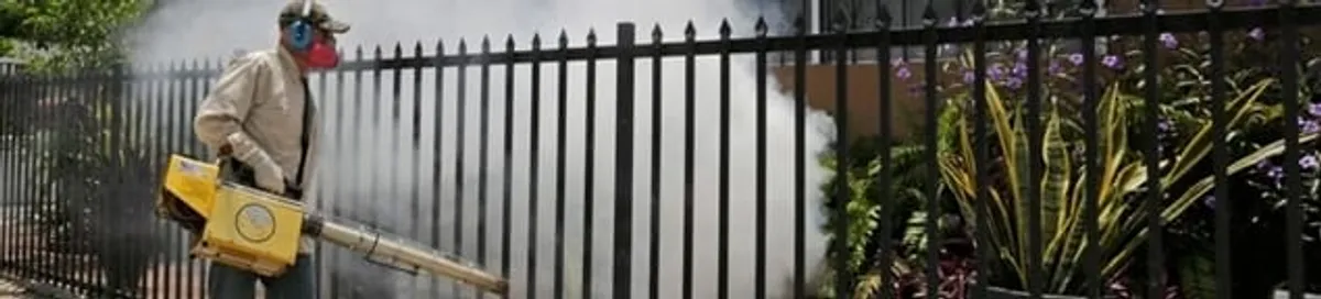 Mosquito control technician fogging a yard perimeter for mosquito reduction in Eugene, OR